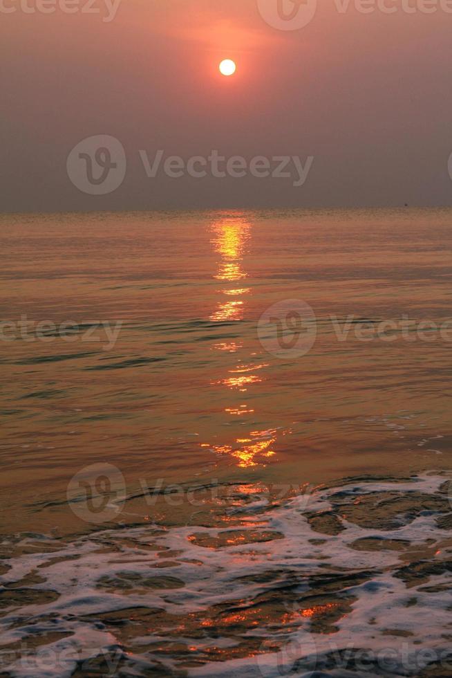 The sun is rising, the sun is bright, the morning sea at Cha-Am Beach photo