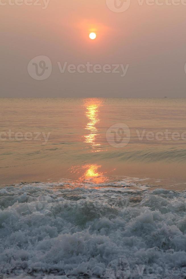 The sun is rising, the sun is bright, the morning sea at Cha-Am Beach photo