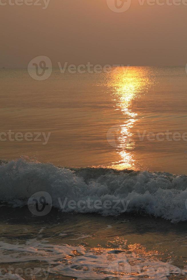 The sun is rising, the sun is bright, the morning sea at Cha-Am Beach photo