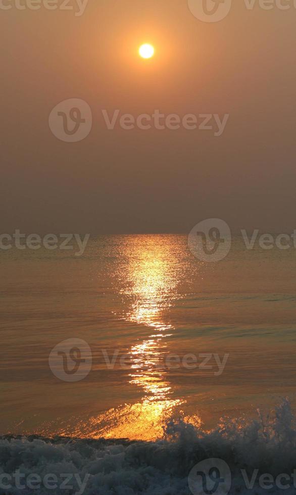 The sun is rising, the sun is bright, the morning sea at Cha-Am Beach photo