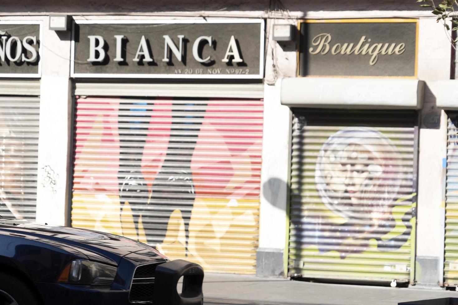 MEXICO CITY, MEXICO - JANUARY 30 2019 - All the shops roll down gates have spray painted graffiti photo