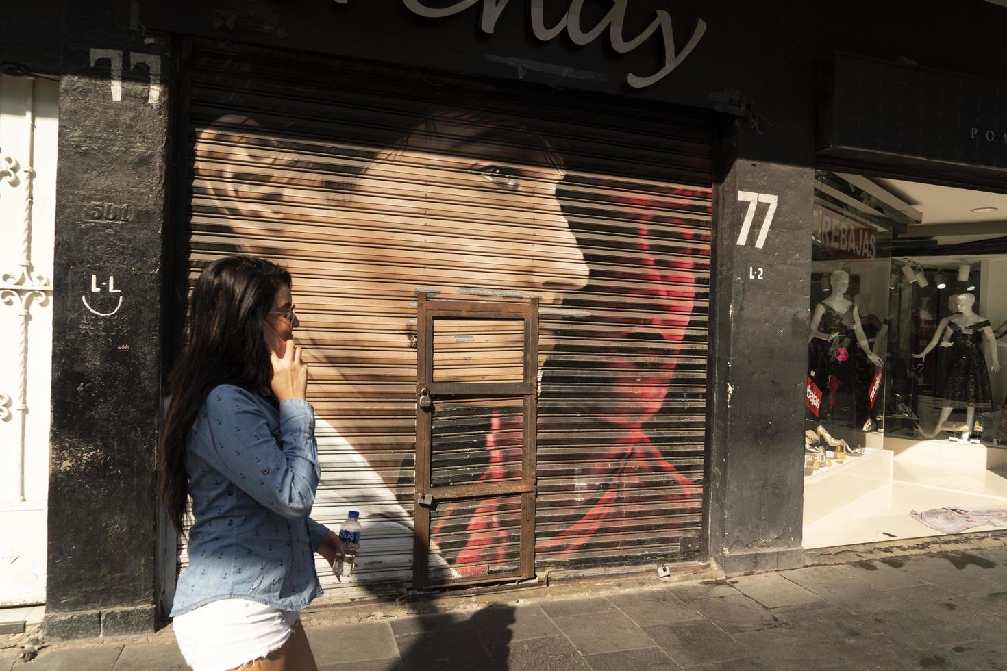 MEXICO CITY, MEXICO - JANUARY 30 2019 - All the shops roll down gates have spray painted graffiti photo