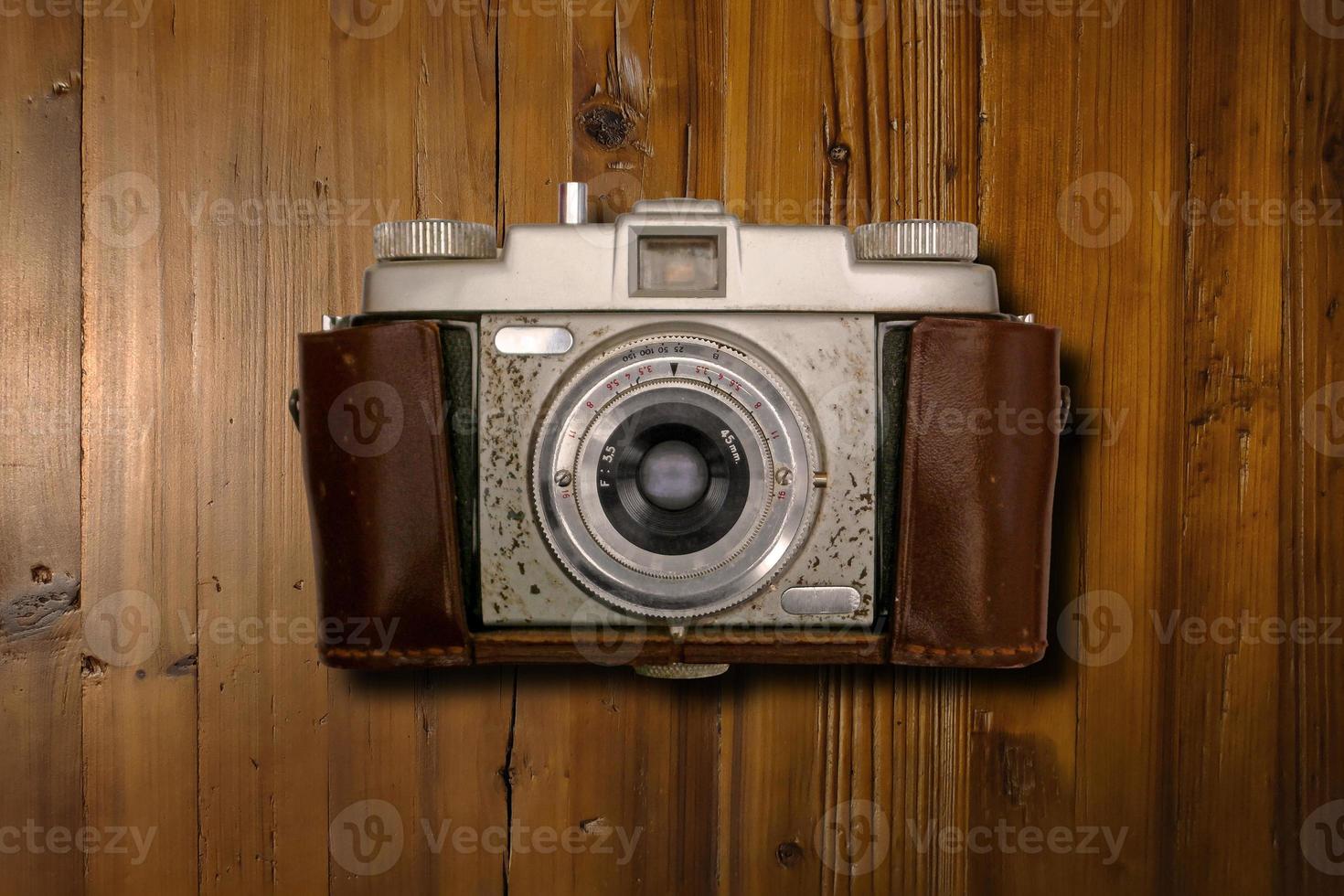 Vintage camera on a wooden desk photo