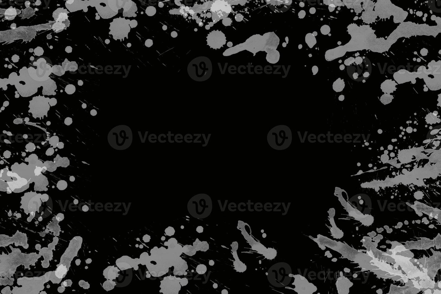 Black and white paint splatter on a black background design photo