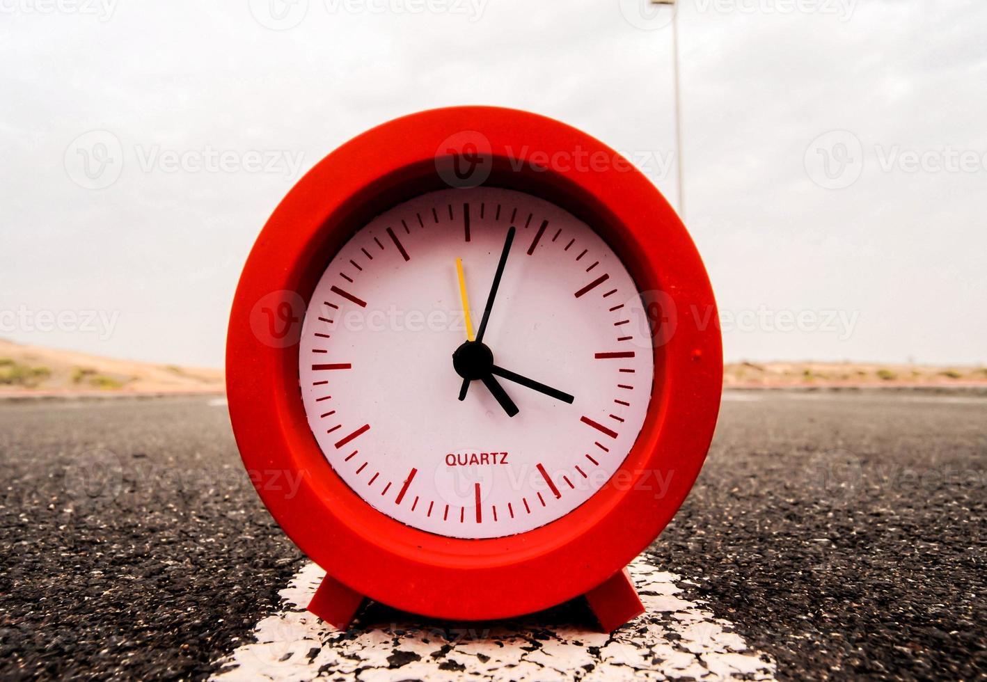 Red clock on the road photo