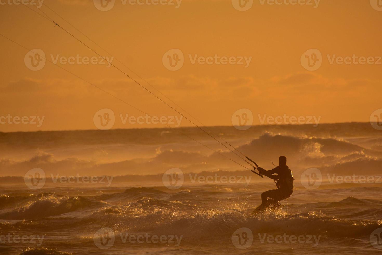 Kitesurfer at sunset photo