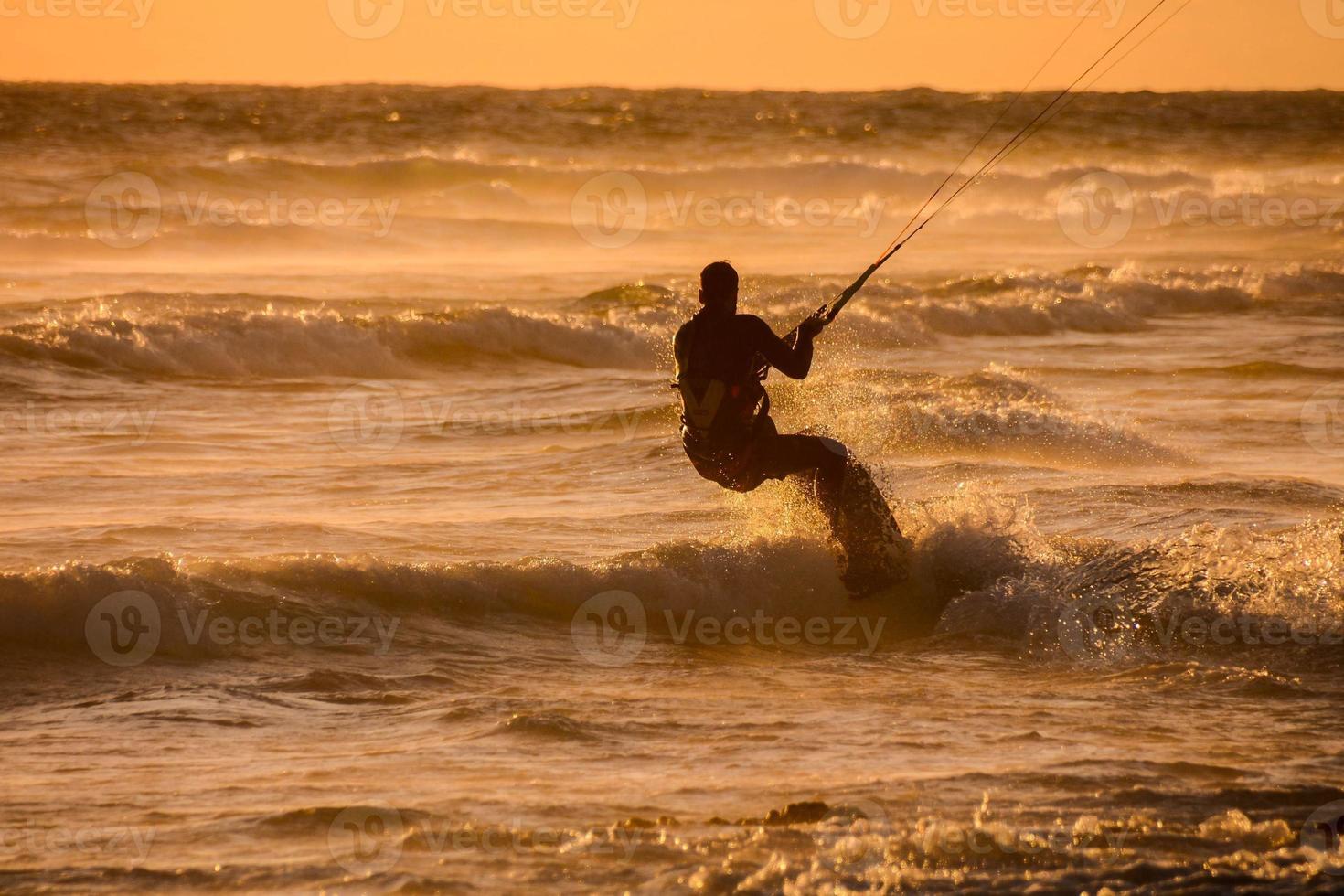 Kitesurfer at sunset photo