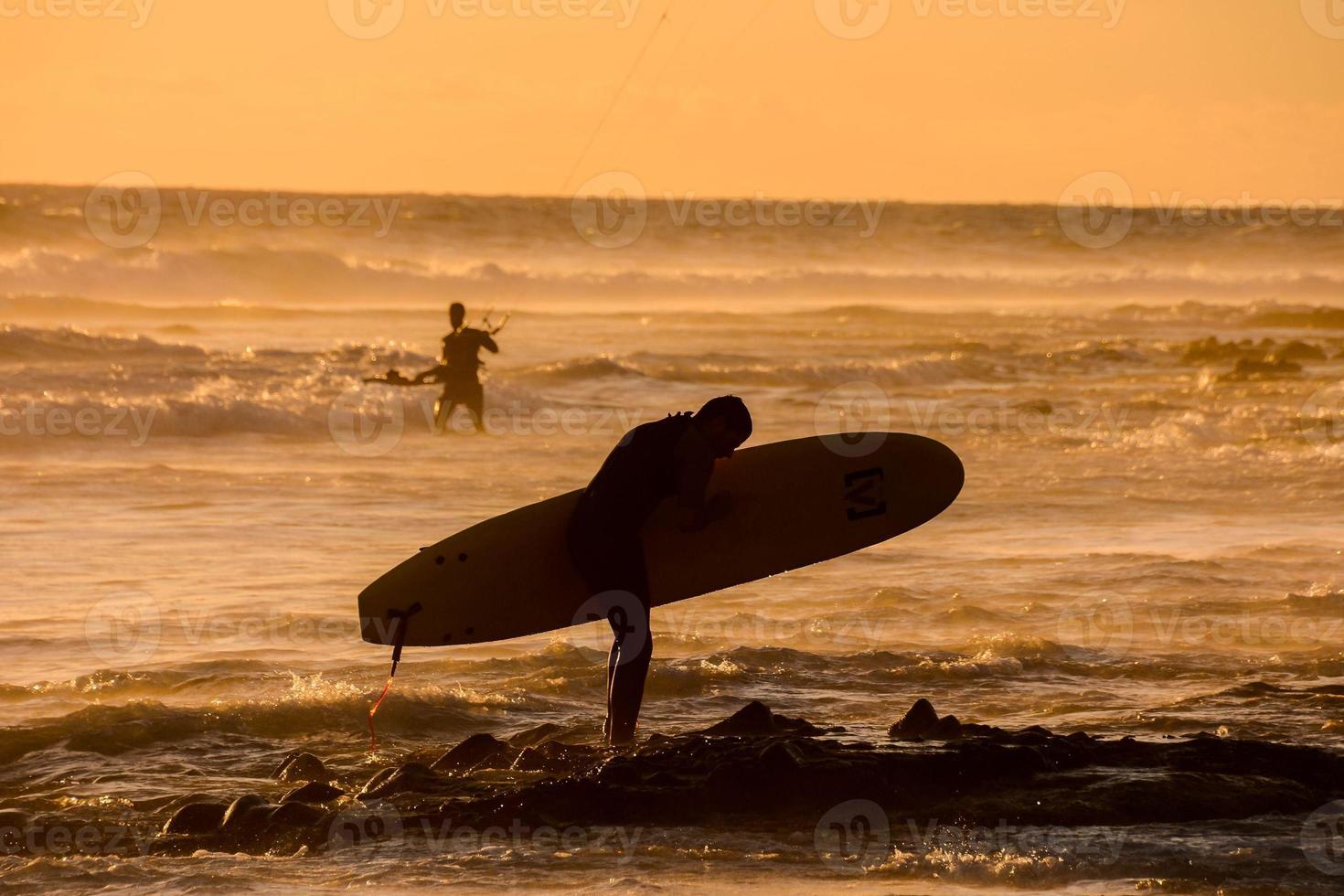 Surfer at sunset photo