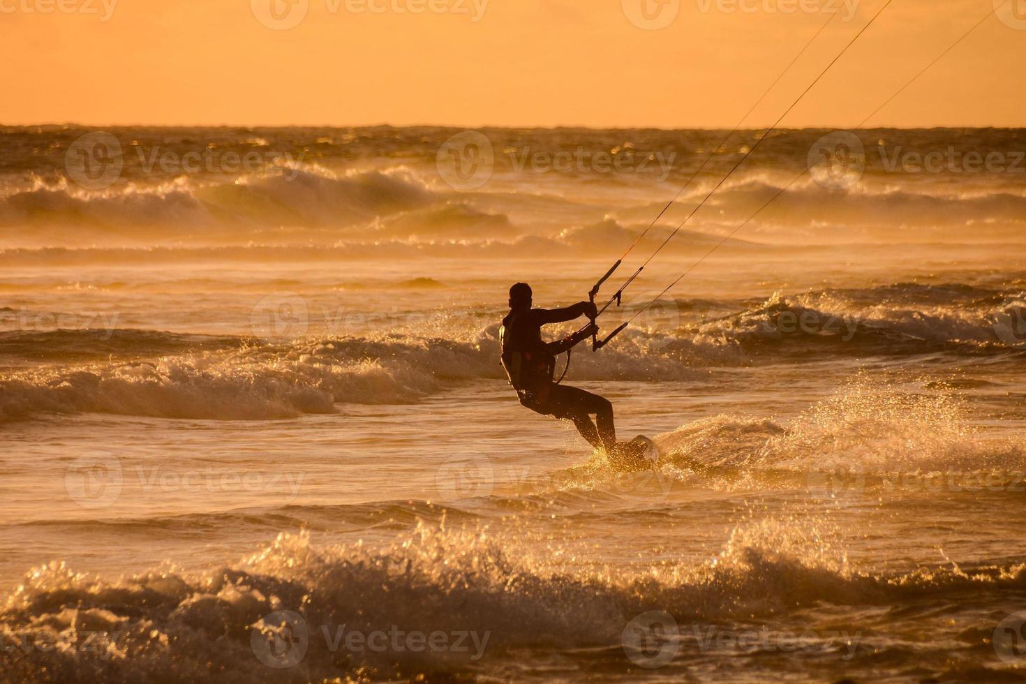 Kitesurfer at sunset photo