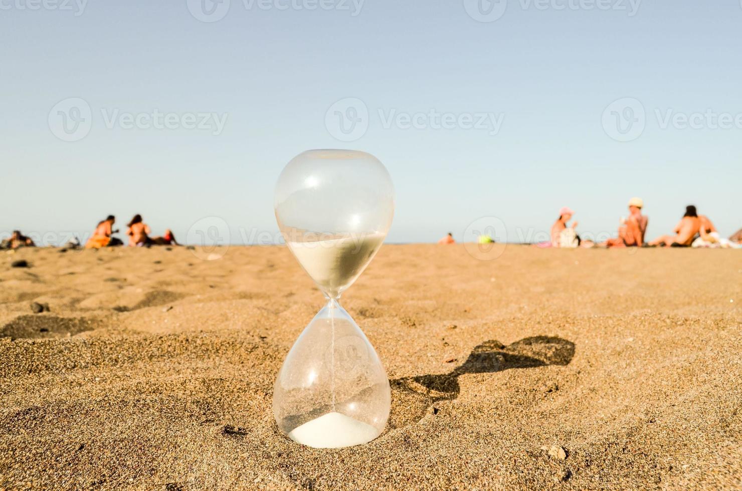 Hourglass in the sand photo