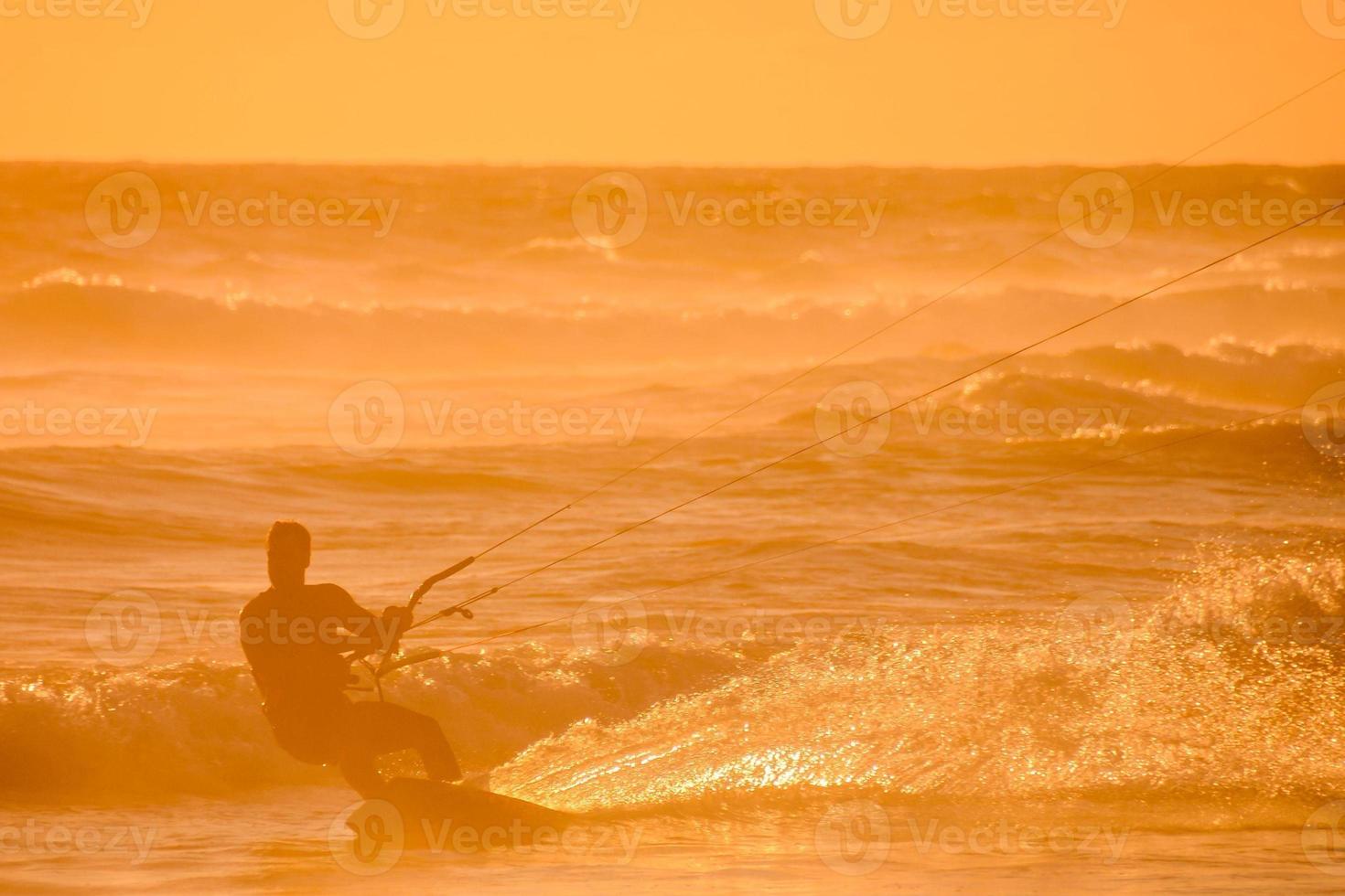 Kitesurfer at sunset photo