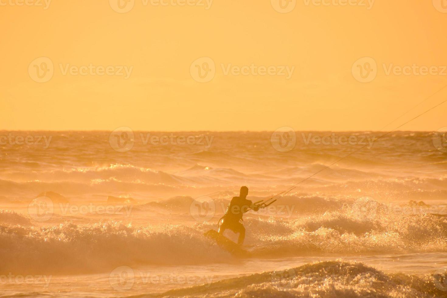 Kitesurfer at sunset photo