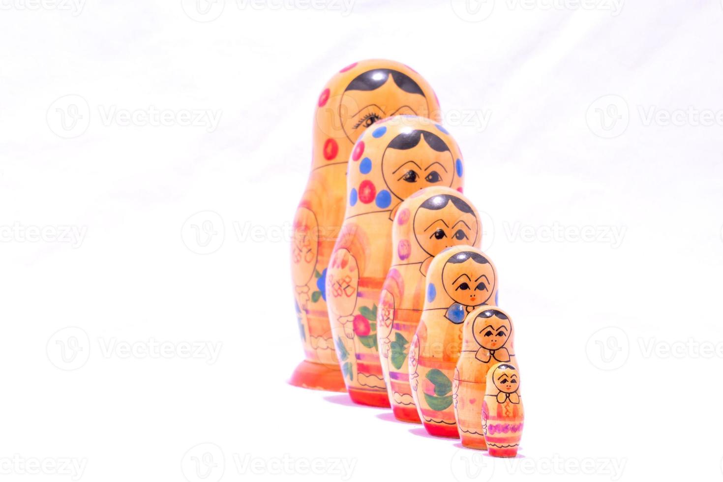 Nesting dolls on light background photo