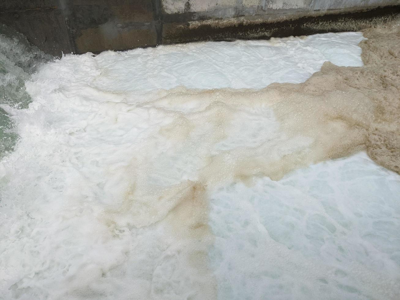 Texture and surface of seawater fall on the power plant with foaming on the outfall. The photo is suitable to use for industry background, environment poster and nature content.