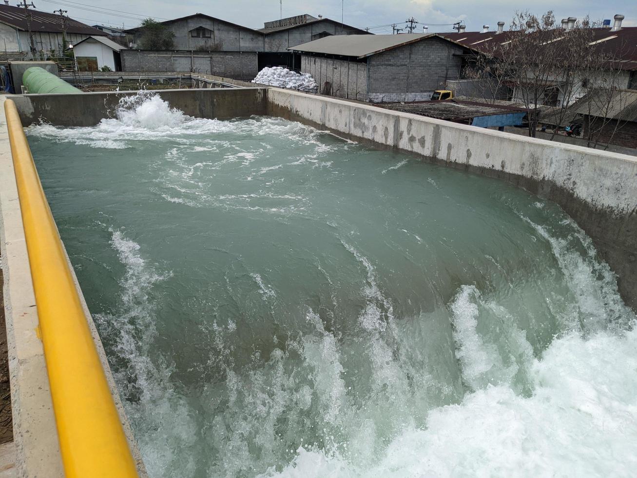 Texture and surface of seawater fall on the power plant with foaming on the outfall. The photo is suitable to use for industry background, environment poster and nature content.