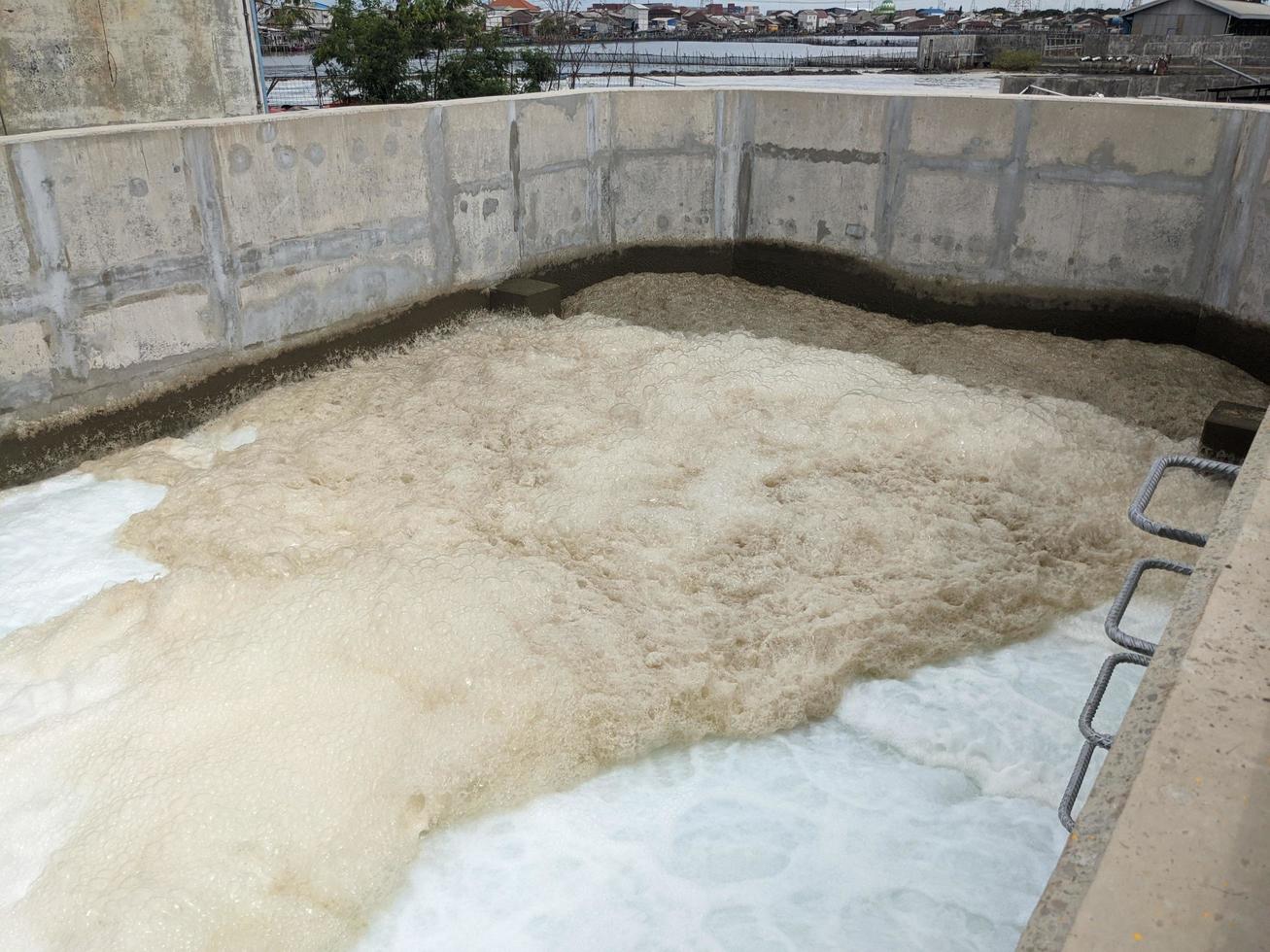 Texture and surface of seawater fall on the power plant with foaming on the outfall. The photo is suitable to use for industry background, environment poster and nature content.