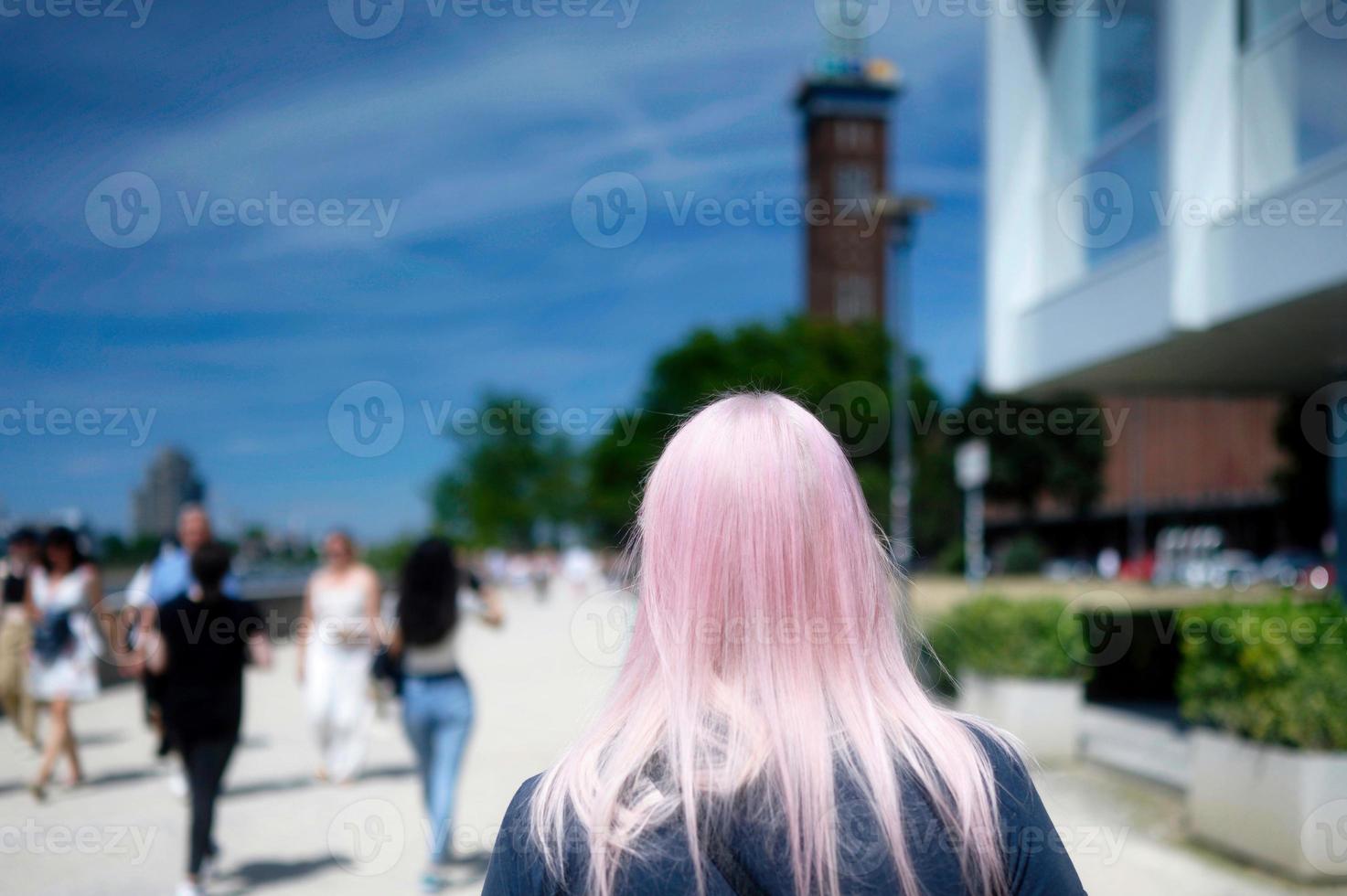 tourists walking on the rhine promenade in cologne deutz on a sunny summer day photo