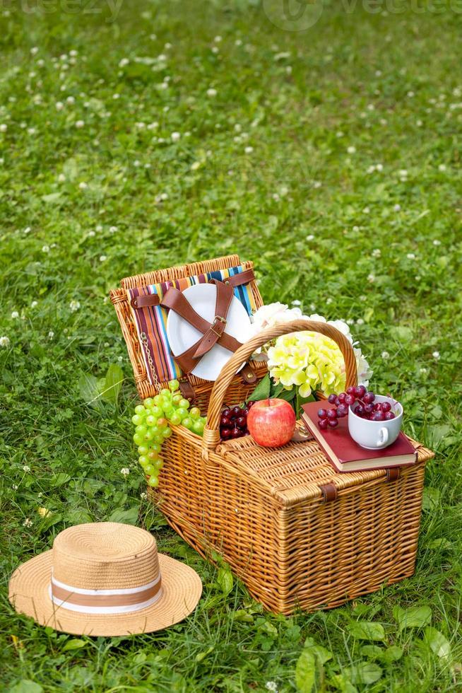 picnic basket on green grass. copy space. photo