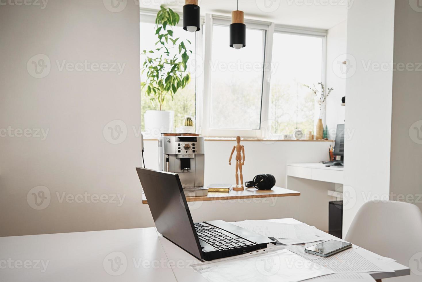 hogar oficina. ordenador portátil en mesa en el cocina foto
