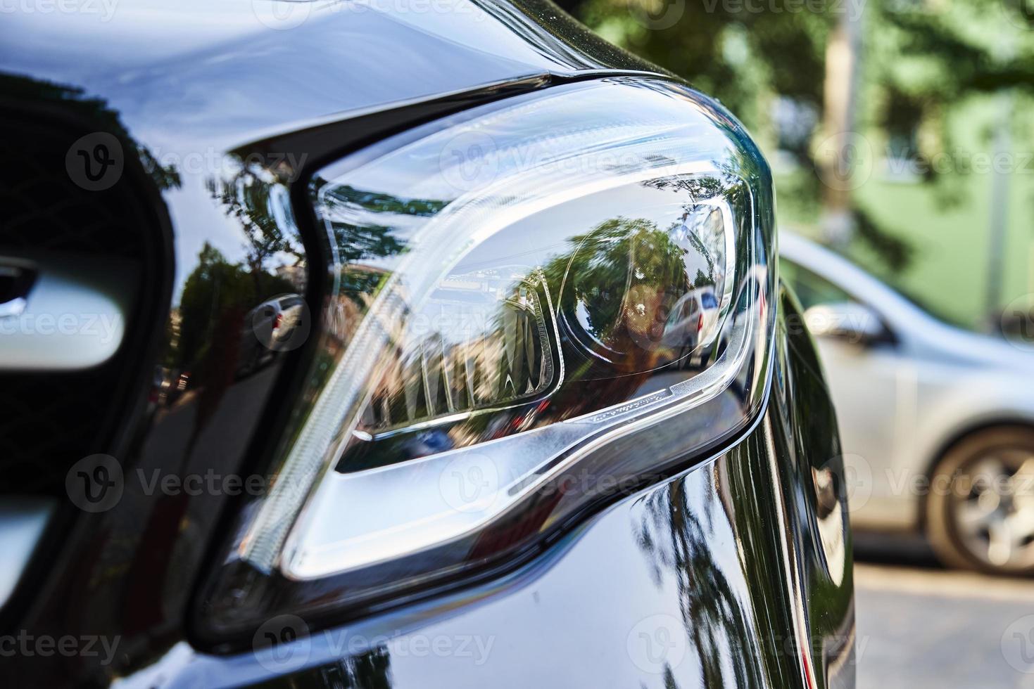Headlight with halogen lamp on modern car, closeup photo