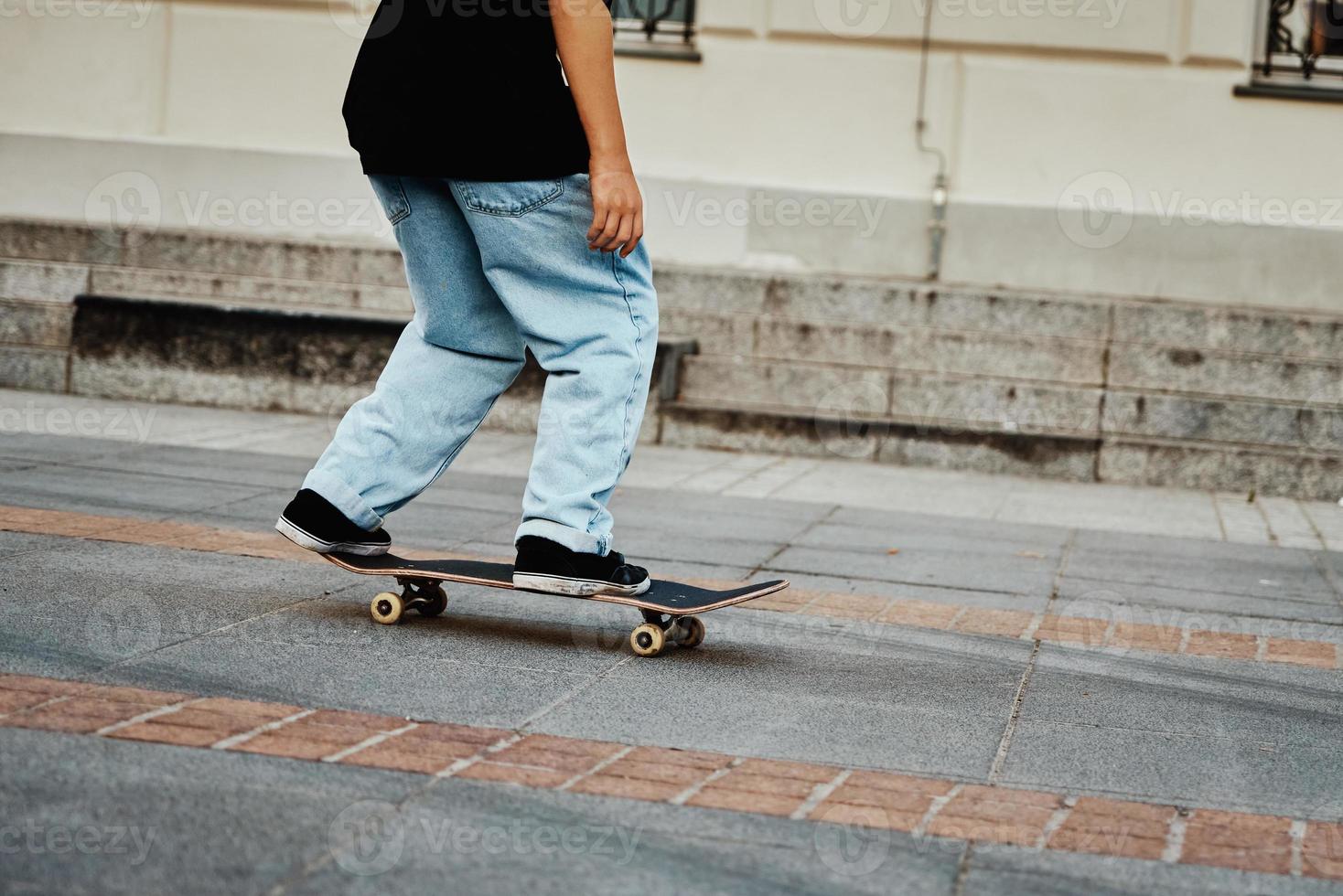 Skateboarder ride on skateboard at city street, close up photo