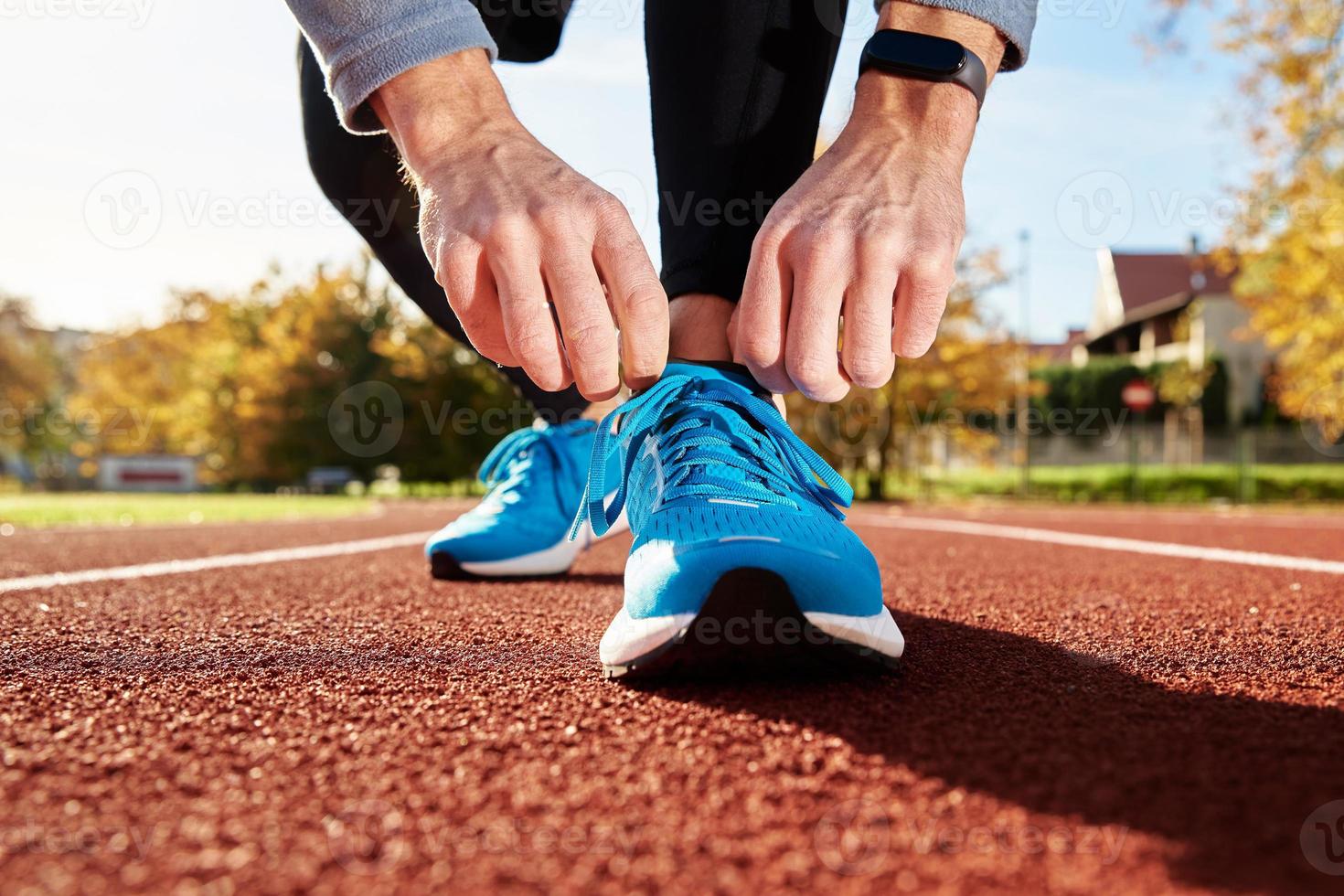 Runner get ready for run, tying sneakers shoelaces photo