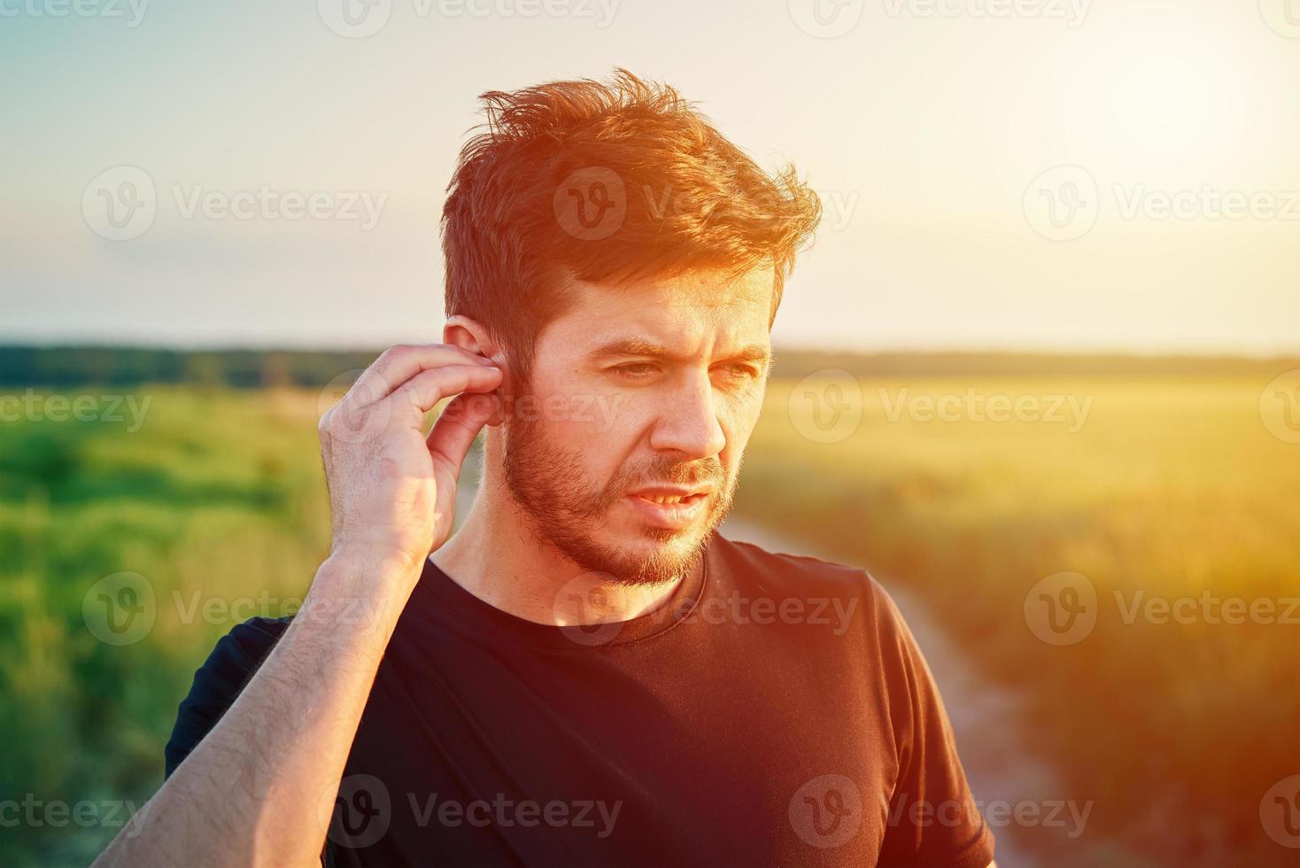 Active millenial man portrait outdoors at sunset photo