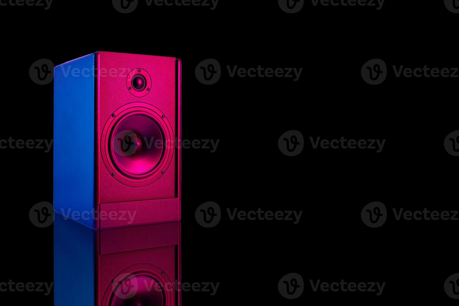 Stereo speaker with neon light on dark background photo