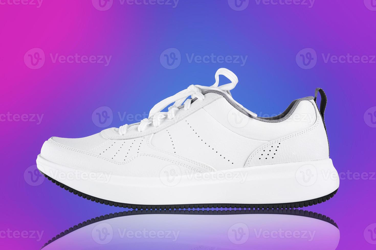 White sneaker on colorful background. New unbranded sport shoe photo