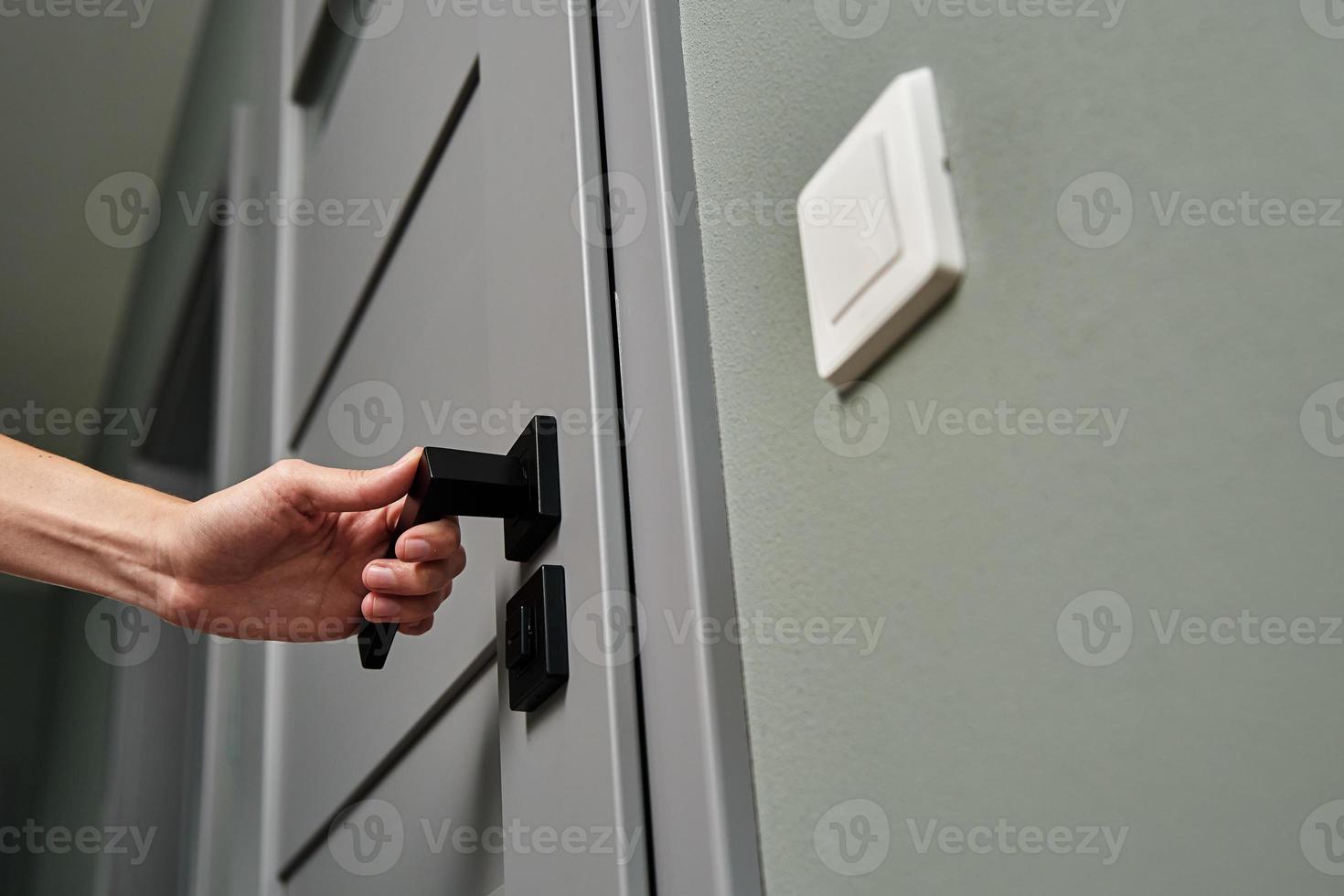 Woman open door and entrance in the room photo