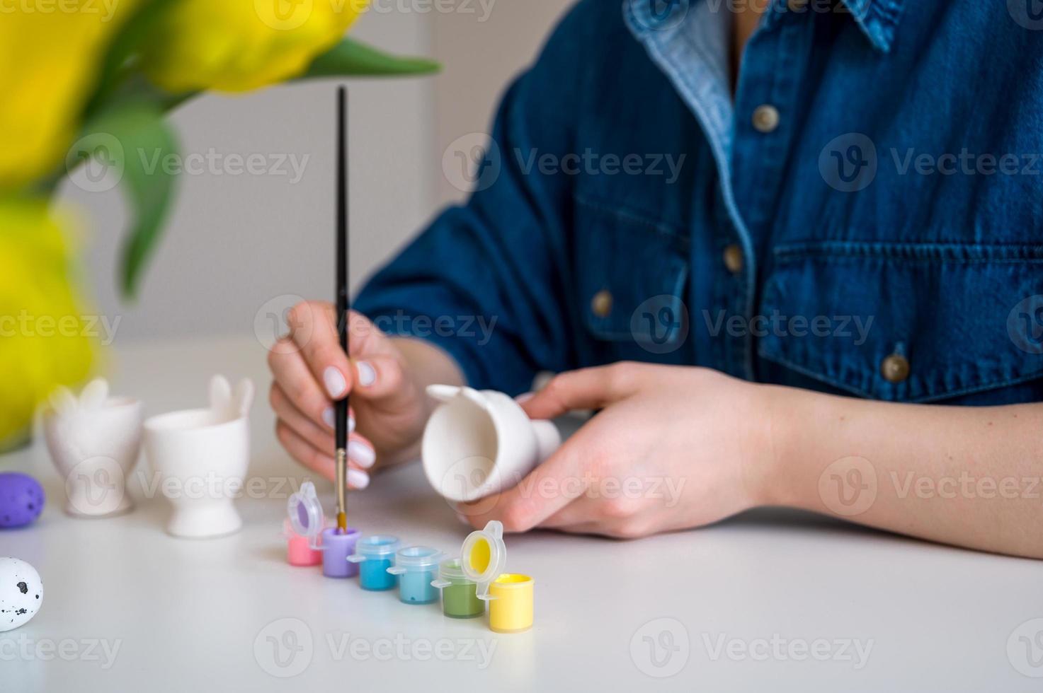 Pastel color Easter egg holder. Woman preparing for spring holiday photo