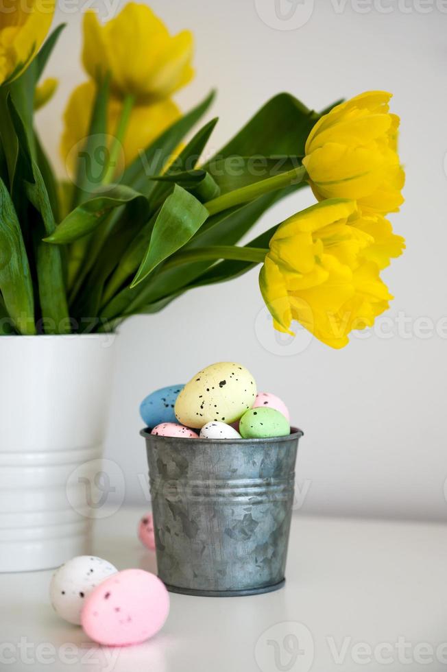 Vertical easter banner with vase and tulips and pastel eggs in a small bucket photo