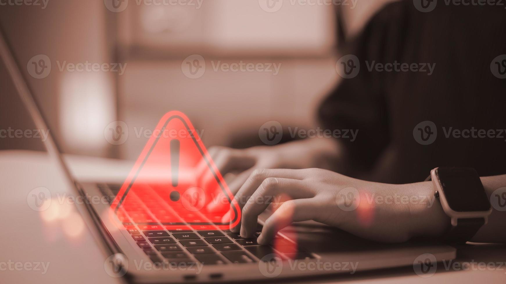 developer using computer laptop with triangle caution warning sign for notification error and maintenance concept. photo