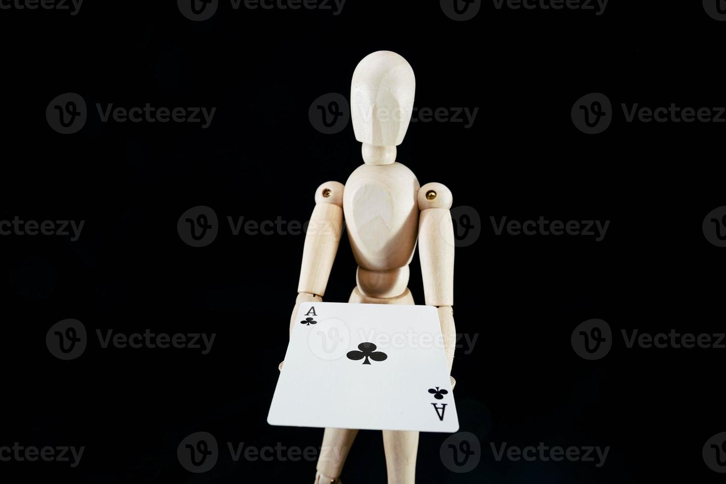 Wooden mannequin on dark background photo