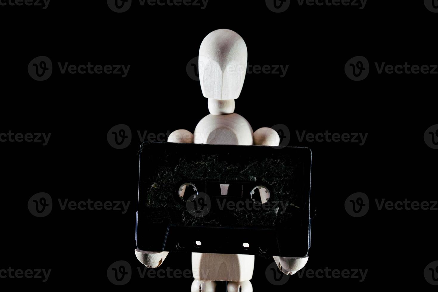Wooden mannequin on dark background photo