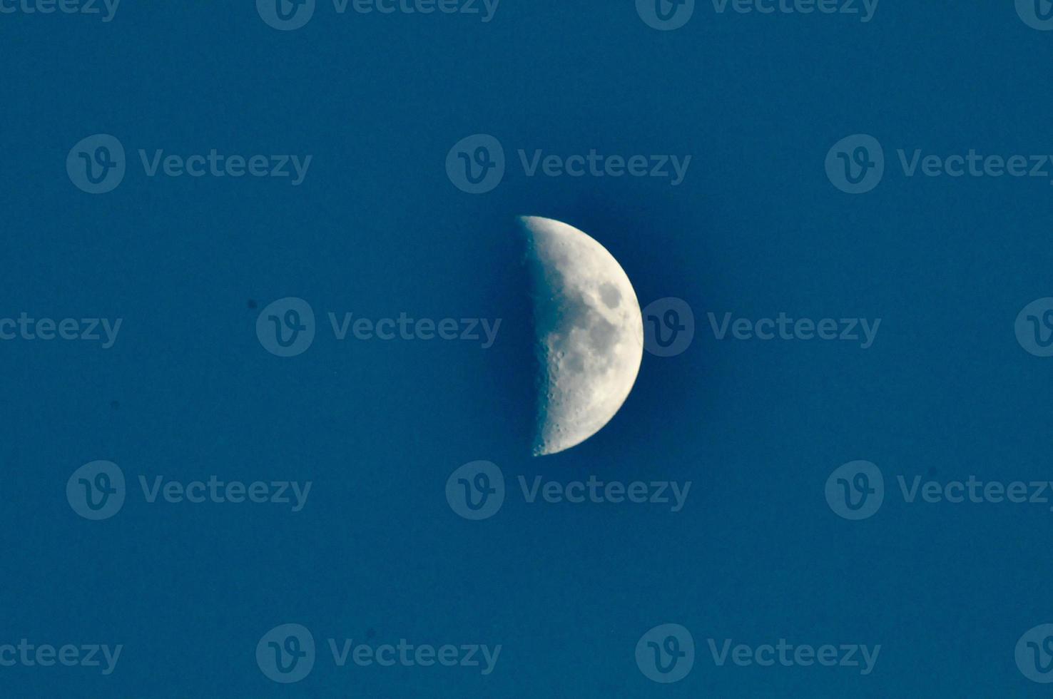 Moon on dark blue sky photo