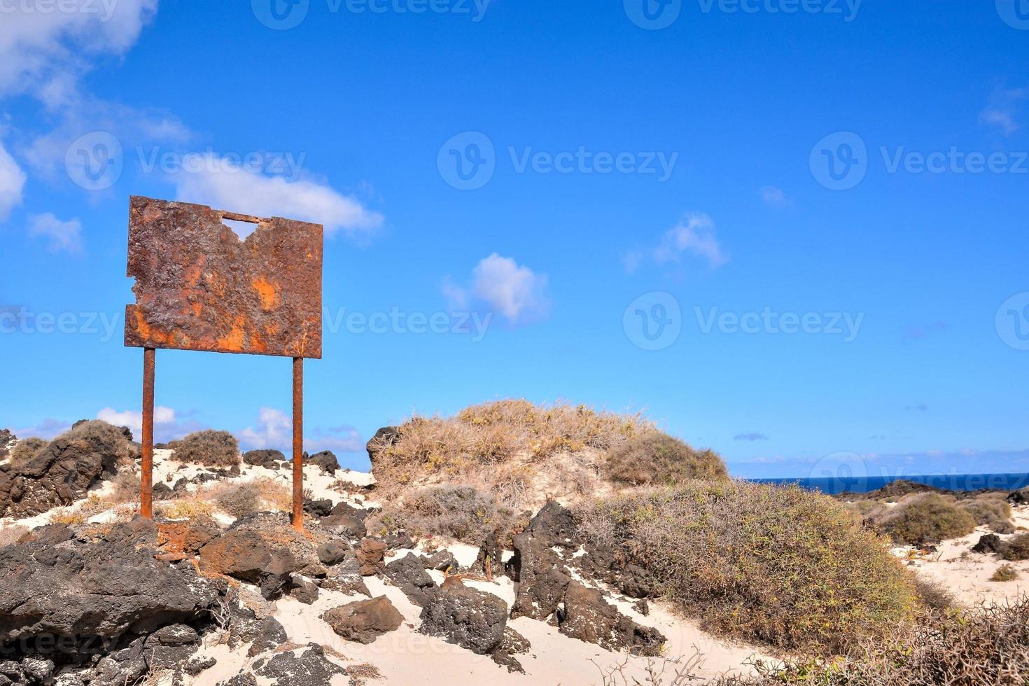 Rusty sign on the coast photo