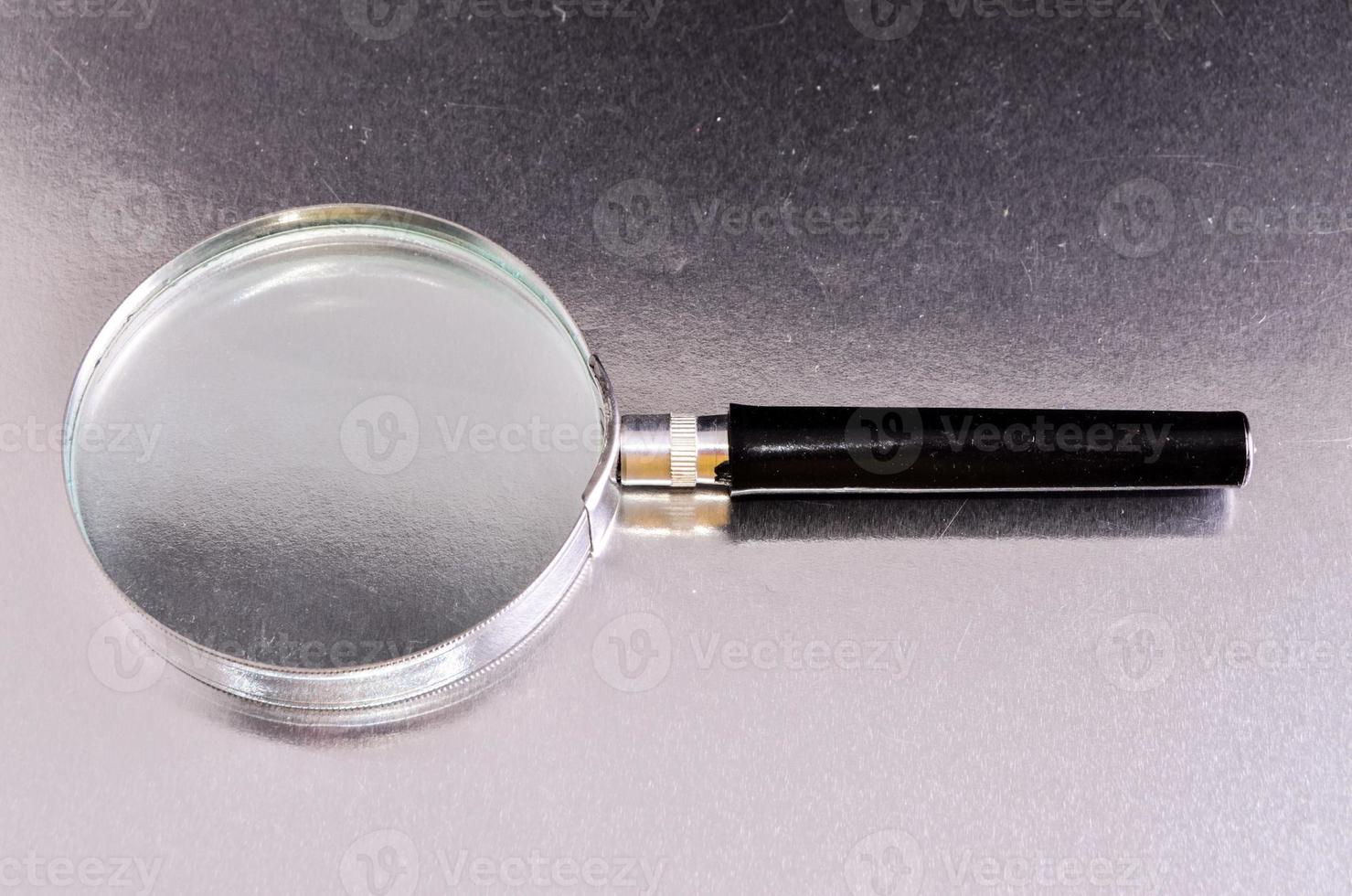 Magnifying glass on metal photo