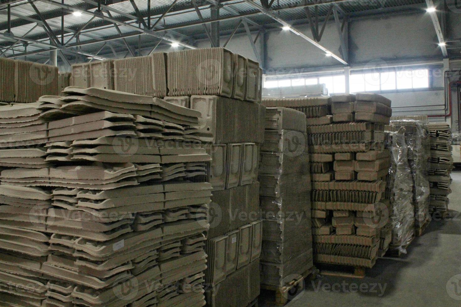 Storage warehouse with packaged goods on wooden pallet at recycle paper factory. Preparation shipment of products. Logistics, transportation and distribution facility for delivery. Supply chain cargo photo