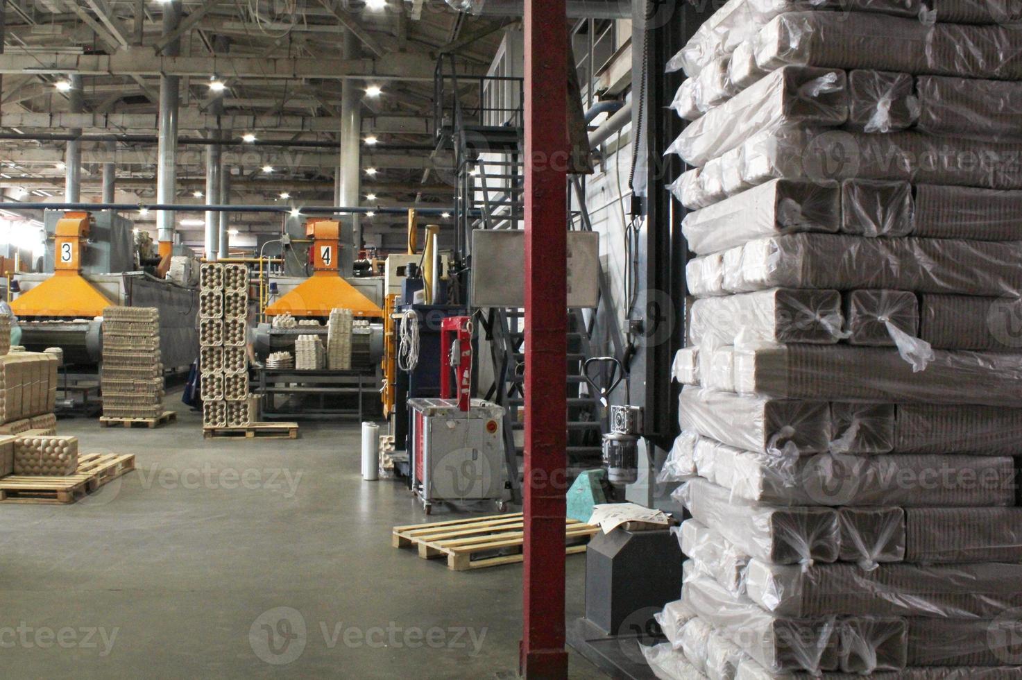 Storage warehouse with packaged goods on wooden pallet at recycle paper factory. Preparation shipment of products. Logistics, transportation and distribution facility for delivery. Supply chain cargo photo