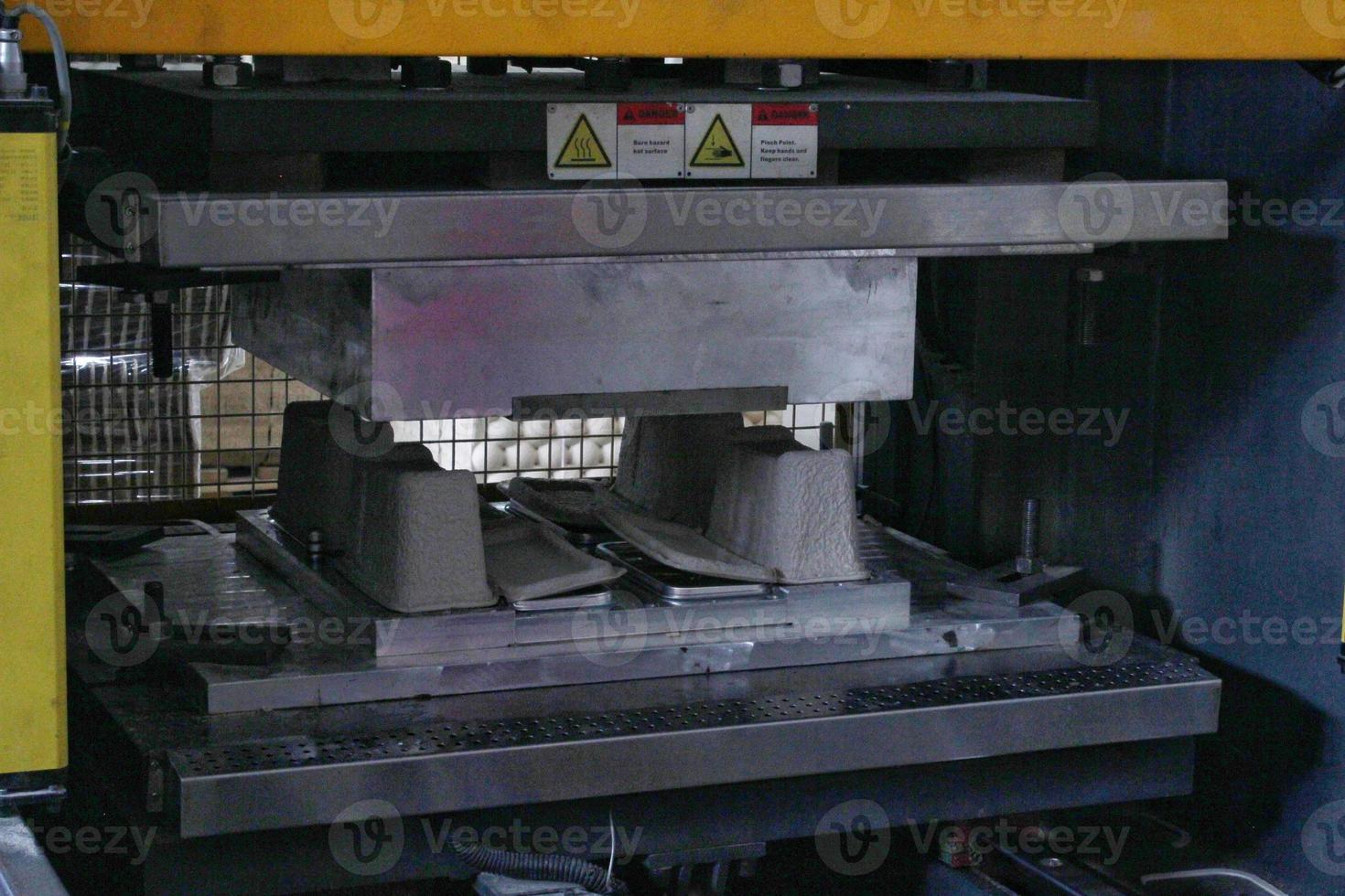 Machine equipment for manufacture of package from pulp carton recycle paper. Conveyor line on modern factory of production cardboard box. Reuse materials concept photo