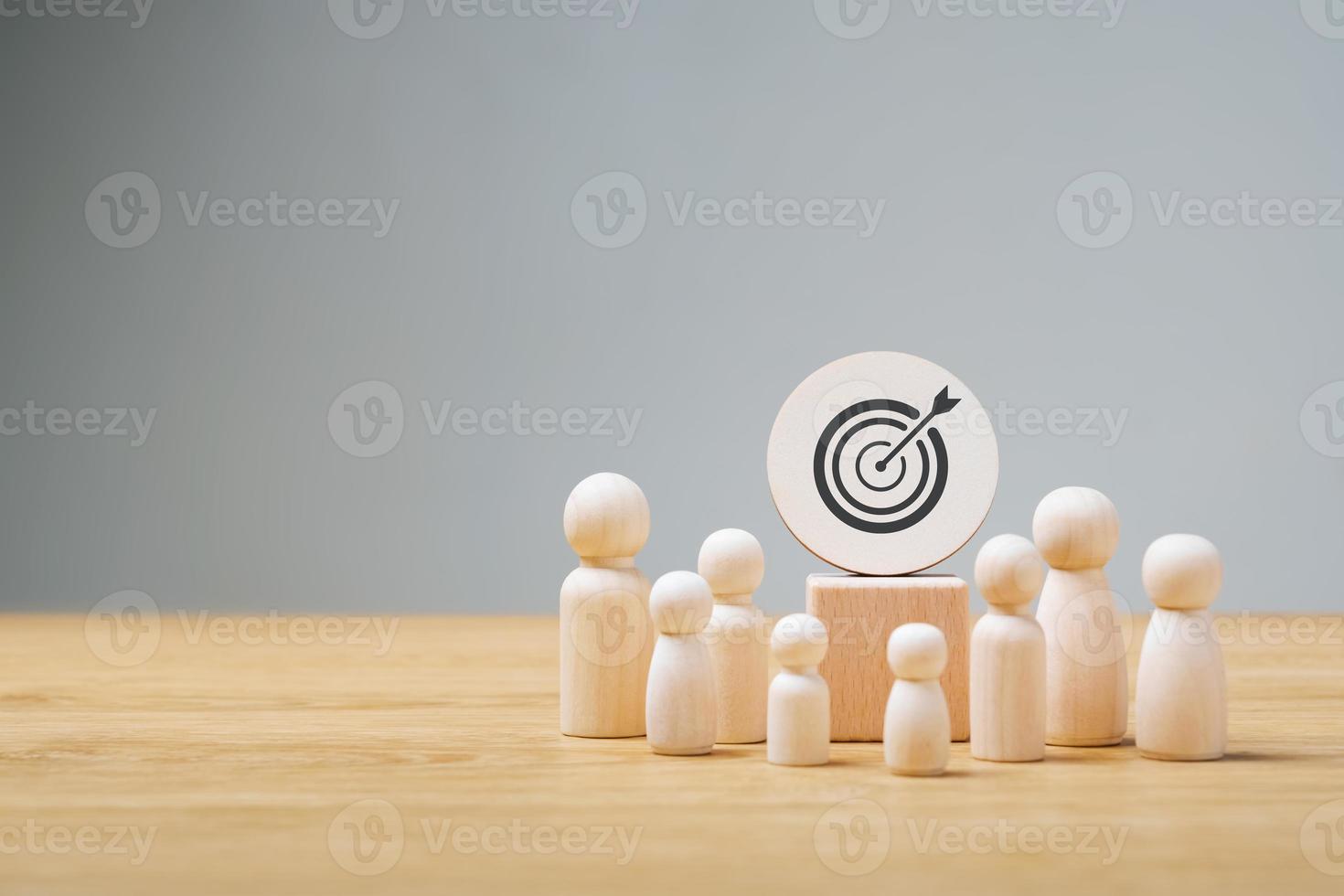 Goal setting concept for success, wooden doll. Dart board and arrows for goals, goals and future business success. photo