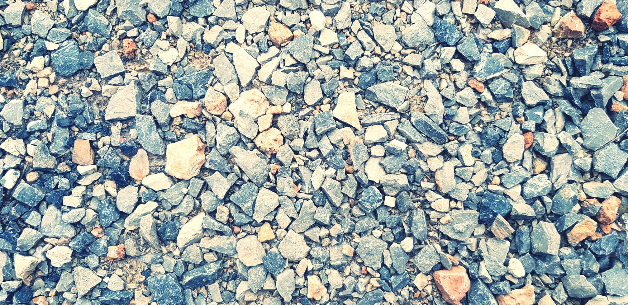 Pattern of small gravel, rock or stone on the ground for background in blue vintage color tone. Hard material, Art or Textured wallpaper and Group of object concept photo