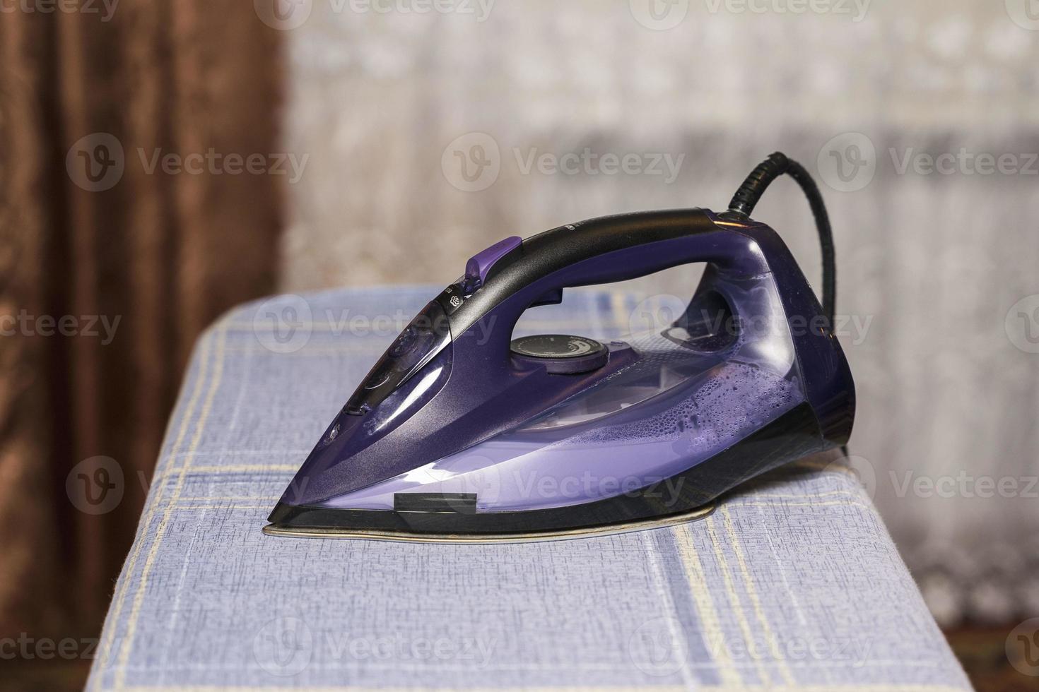 Iron on ironing board at home, lifestyle, home routine, bed linen photo