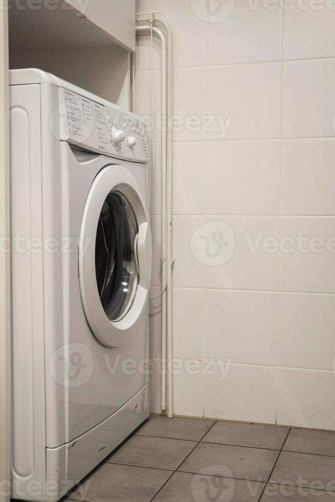 white washing machine in the corner of the bathroom, home life photo