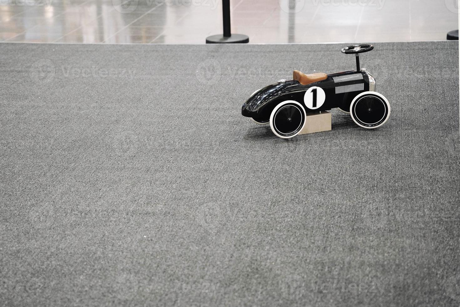 children's racing car with a steering wheel for riding small children photo