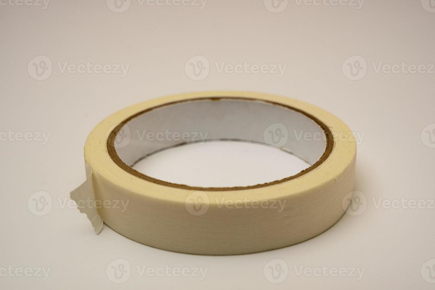 a roll of sticky adhesive tape on a white background photo