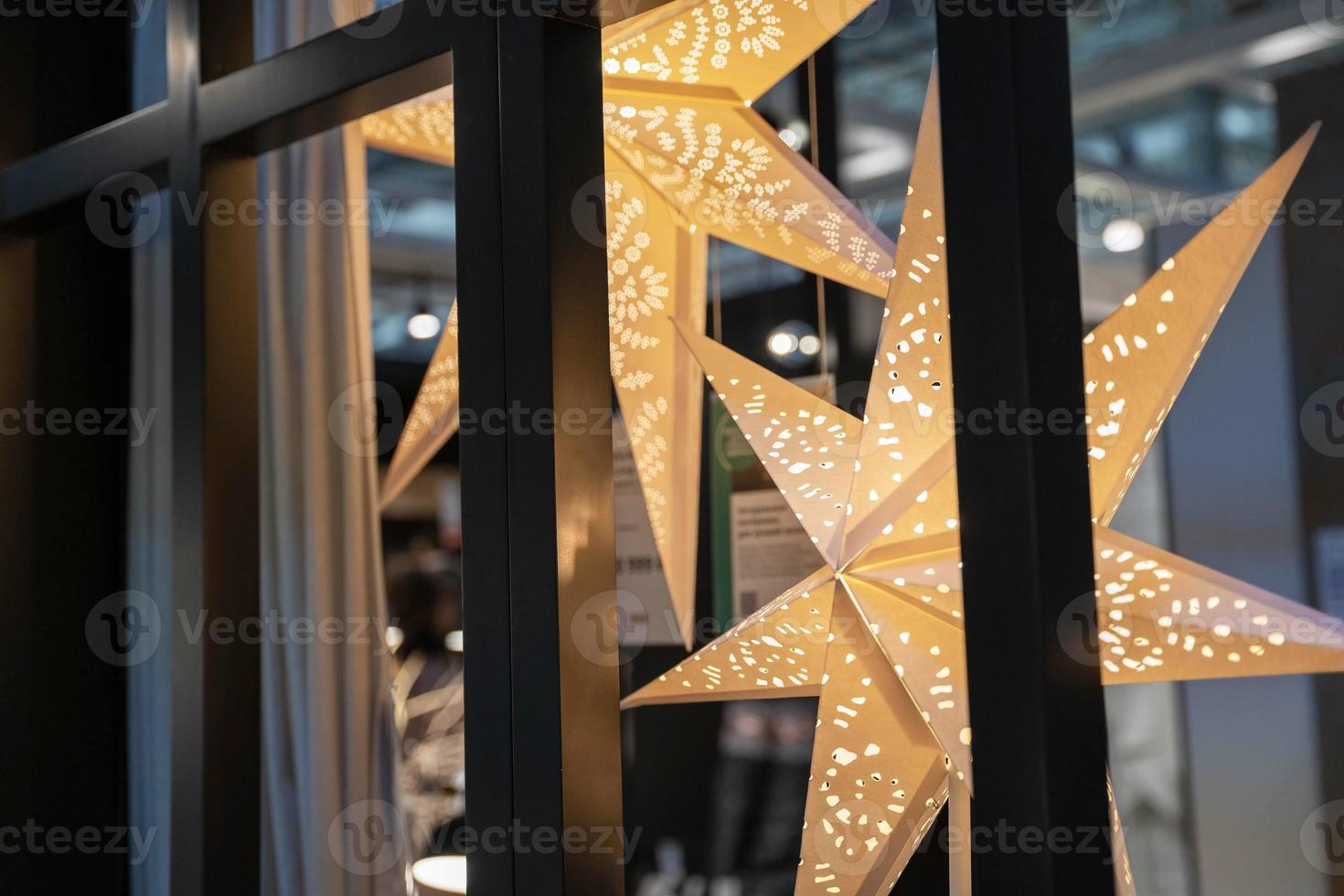 Glowing cardboard Christmas stars. Christmas decor. Merry Christmas and Happy New Year photo