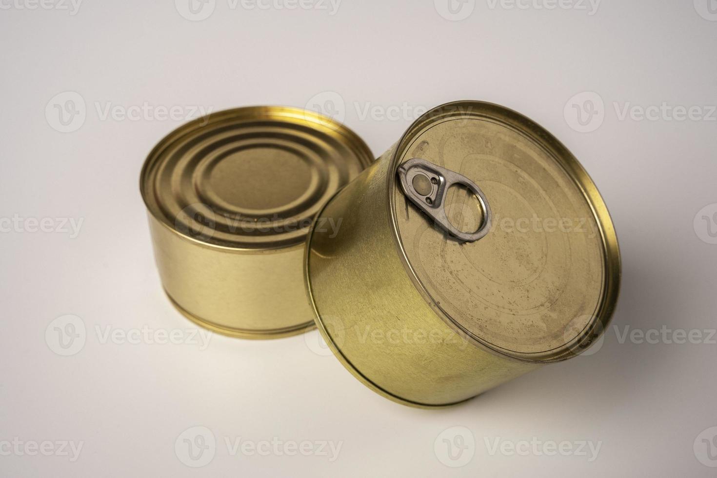 Two shiny tin cans with canned food stand one on one, canned food photo