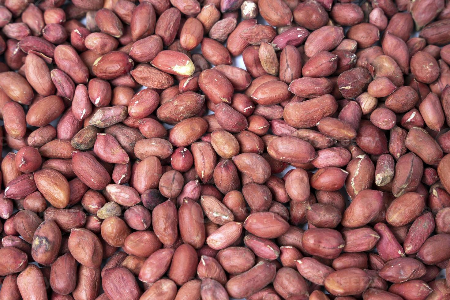 Background of peeled raw peanuts. Peanuts without shells, healthy food photo